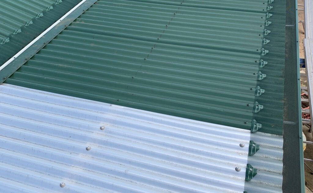 Photo of roof with green gutter guard installed